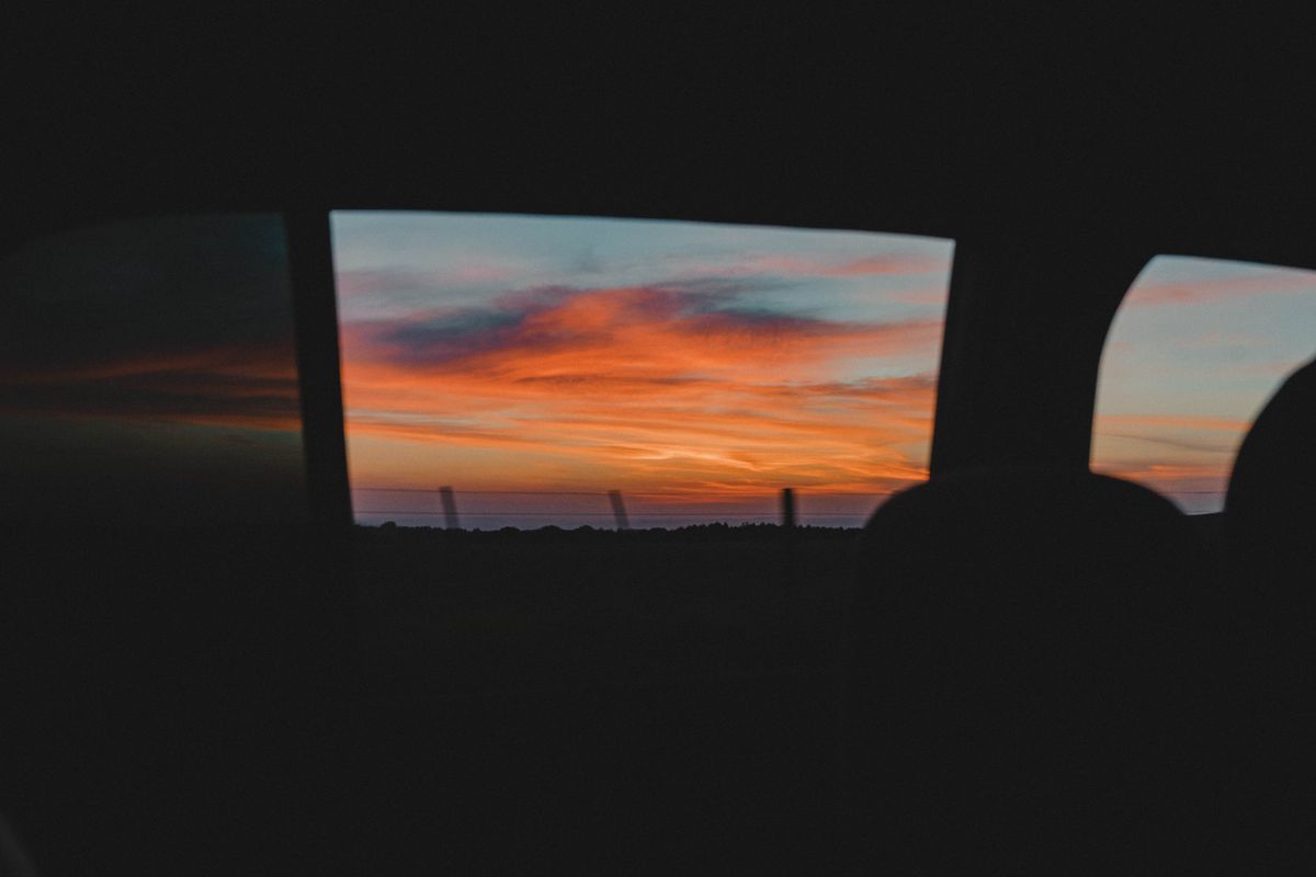 Sunset seen through an open car window